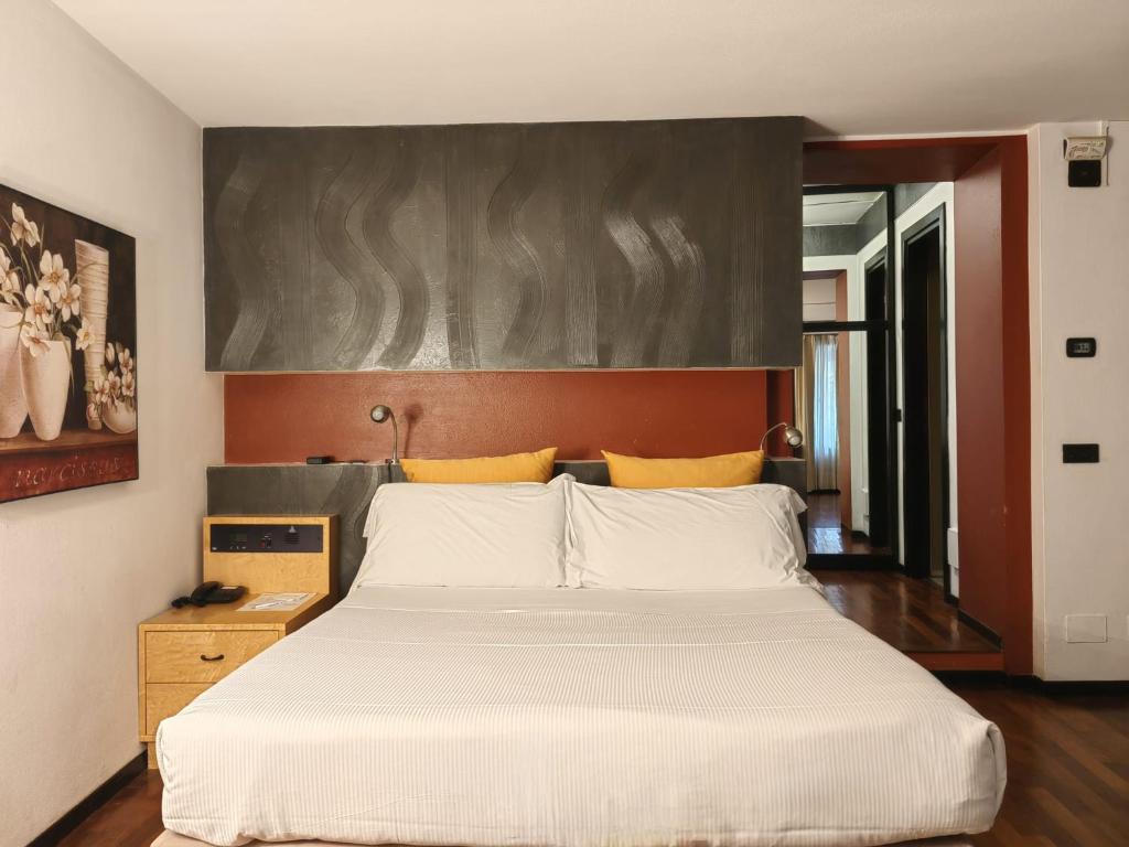 Postel nebo postele na pokoji v ubytování Casa alle Colonne by Hotel Ancora
