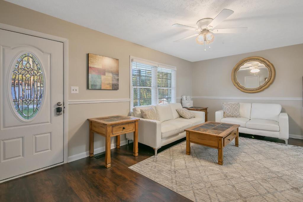 a living room with a couch and a table at Shady Pines Retreat in Hope Mills