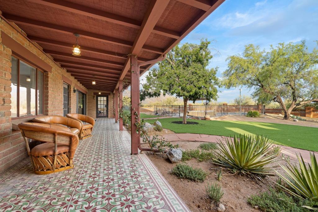 a porch with a row of chairs on a house at Hacienda del Plata in Tucson