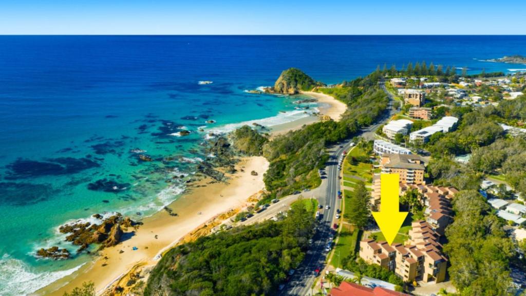 an aerial view of a beach with a yellow arrow at Beachpark Apartments - Close To Beach in Port Macquarie