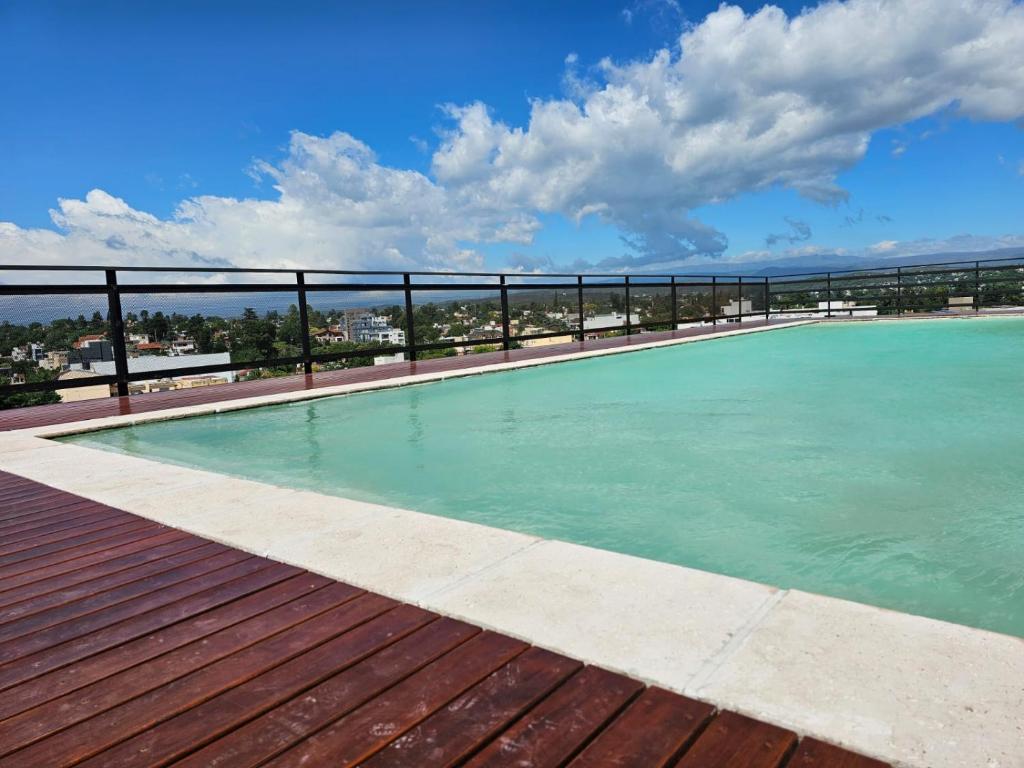 a swimming pool on top of a building at Dpto paseo cibeles in Villa Carlos Paz
