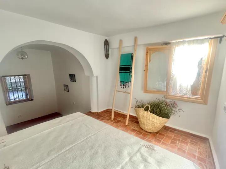 Una cama o camas en una habitación de Dar YAMINA SUIKA