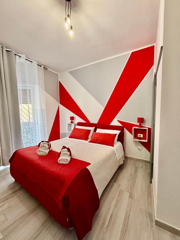 a red and white bedroom with a large bed at Rosaria's Home in Brindisi