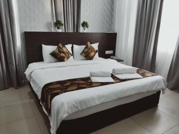 Postel nebo postele na pokoji v ubytování D'Metro Hotel