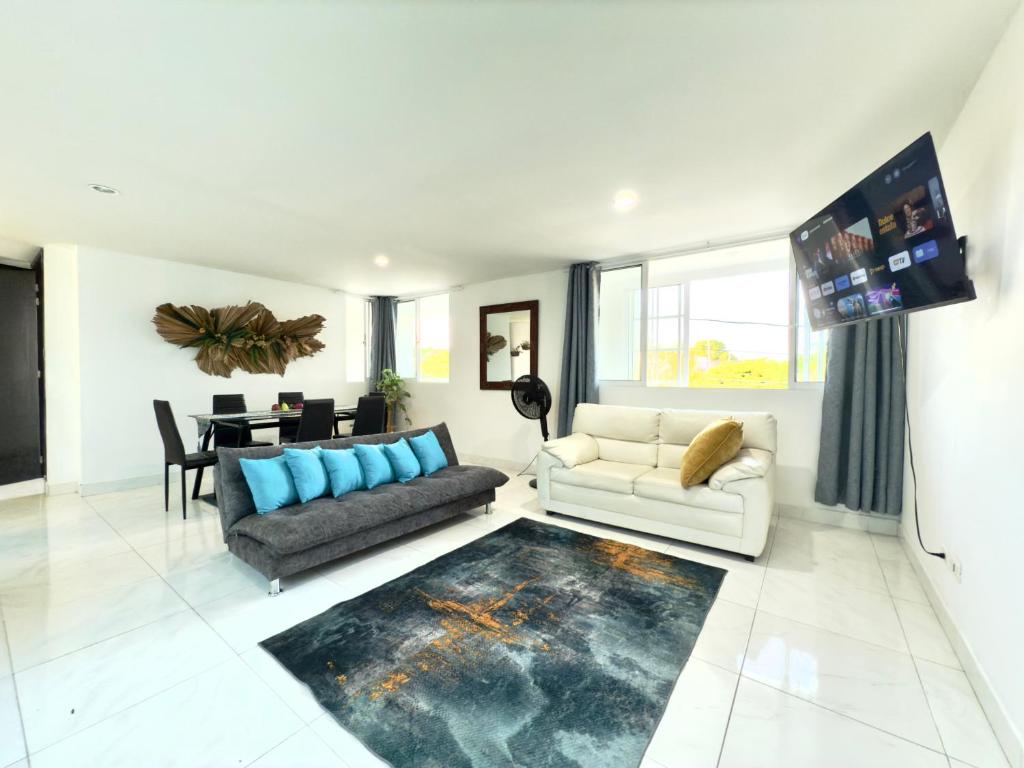 a living room with a couch and a table at Casa Jardin in Cartagena de Indias