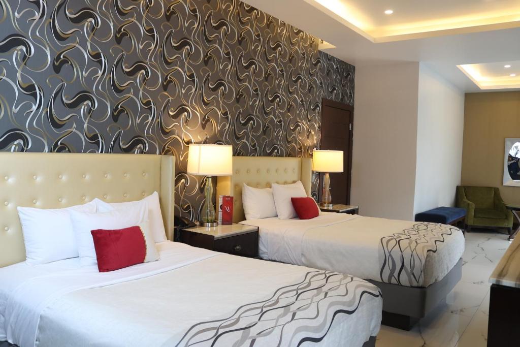 Postel nebo postele na pokoji v ubytování Hotel Wellintown