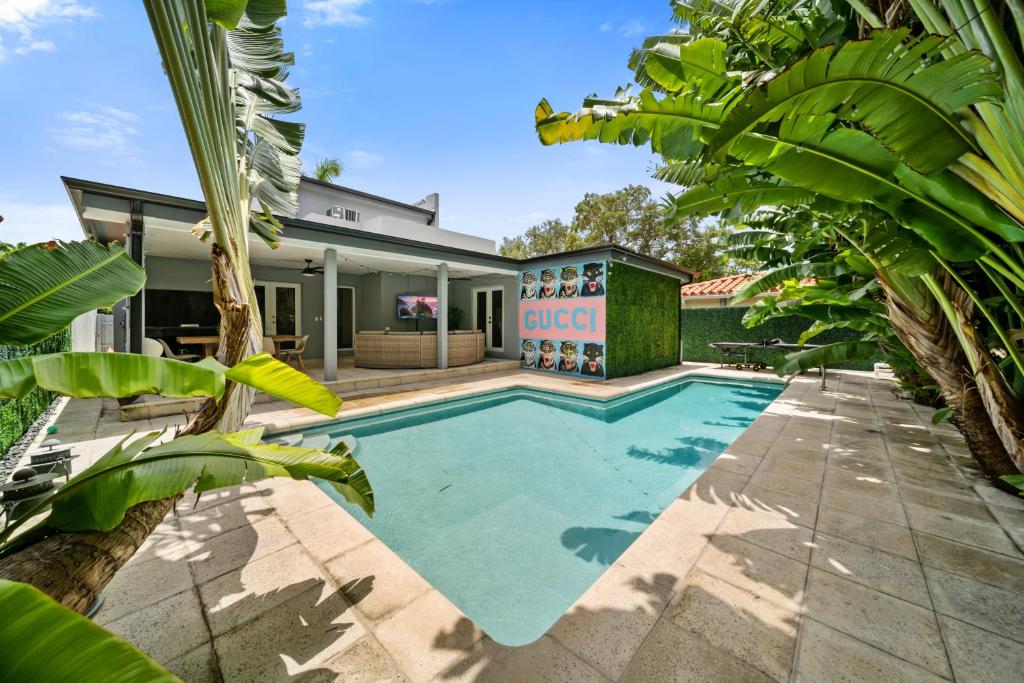 a swimming pool in the backyard of a house at Miami Gucci Home with Pool & Great Location in Miami