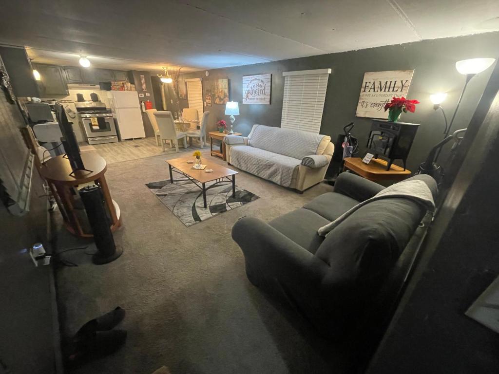 a living room with a couch and a table at USS Clarkston Home in Willie Run Airport