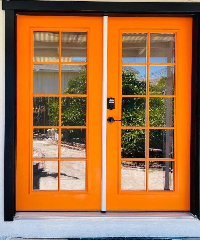 an orange door with two windows on a building at Cozy home Bay Area ROOM 2 in San Jose