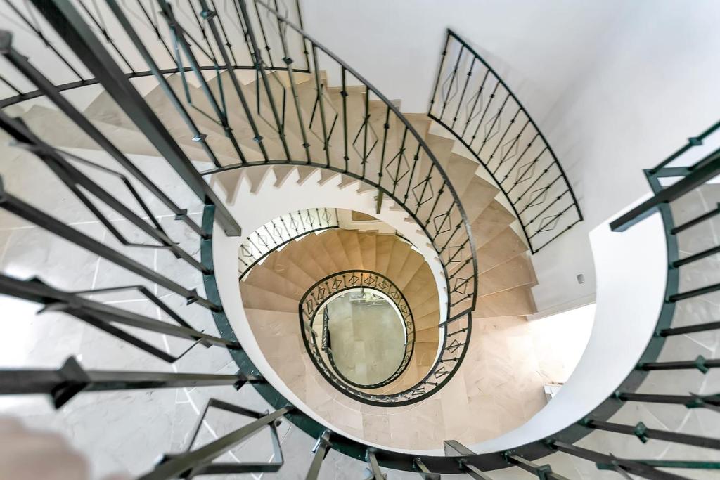 a spiral staircase with a mirror in the middle at Villa Jacqueline in San Roque in La Alcaidesa