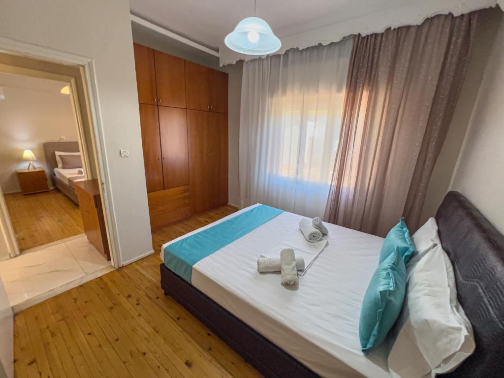 a bedroom with a bed with two towels on it at Sivi's Vacation Homes in Skala Kallirachis