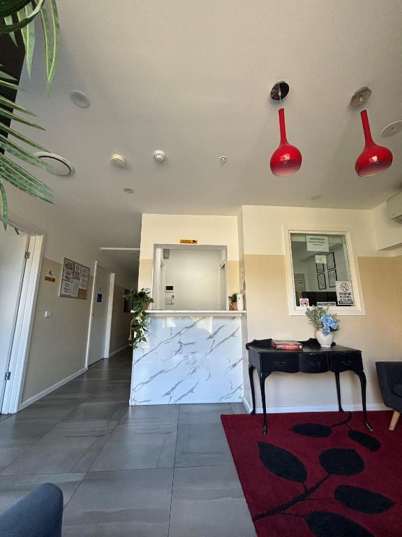 a living room with red lights on the ceiling at St Kilda Accommodation in Melbourne