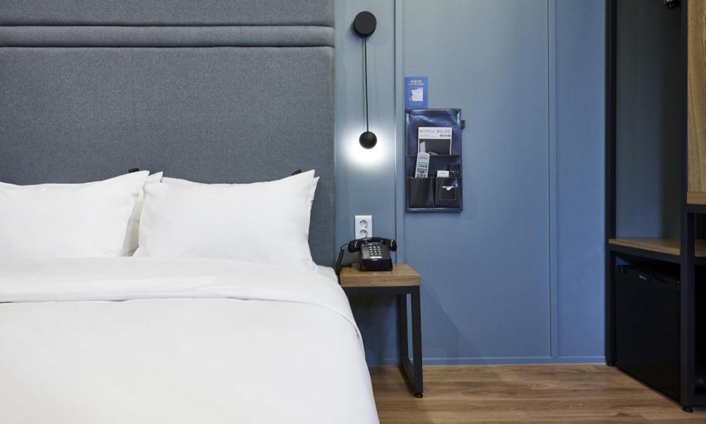 Postel nebo postele na pokoji v ubytování JustSleep Namyangju Dasan
