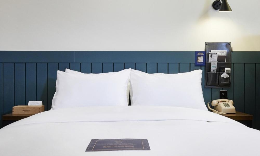 Postel nebo postele na pokoji v ubytování JustSleep Namyangju Dasan