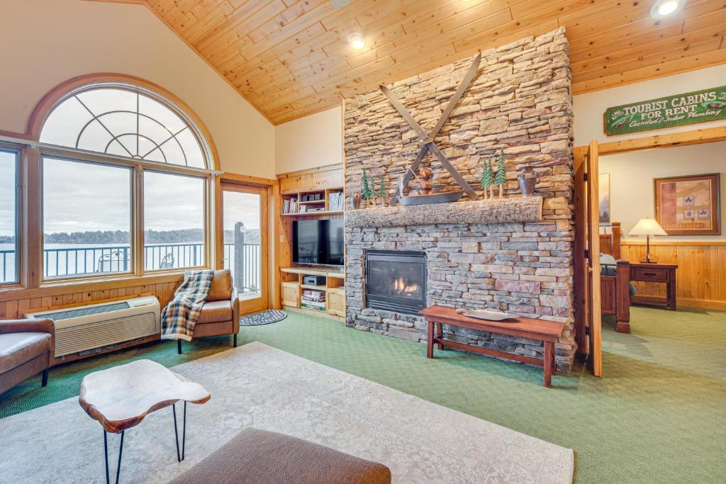 a living room with a stone fireplace in a house at Pool and Lake Access Northern Lakes Retreat! in Two Harbors