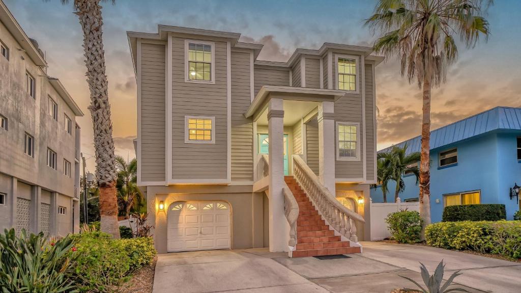 a house with a driveway and palm trees at Island Escape - 638 in Siesta Key