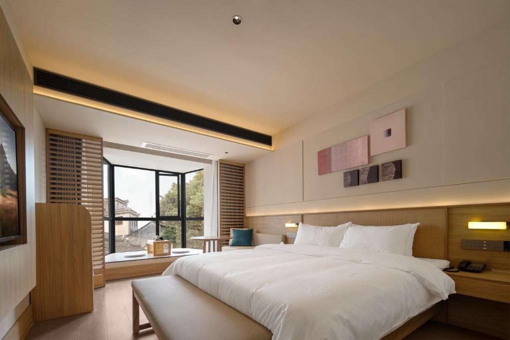 Postel nebo postele na pokoji v ubytování Maiyue Hotel-Xi`an Zhonggulou