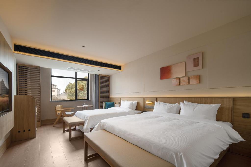 Postel nebo postele na pokoji v ubytování Maiyue Hotel-Xi`an Zhonggulou