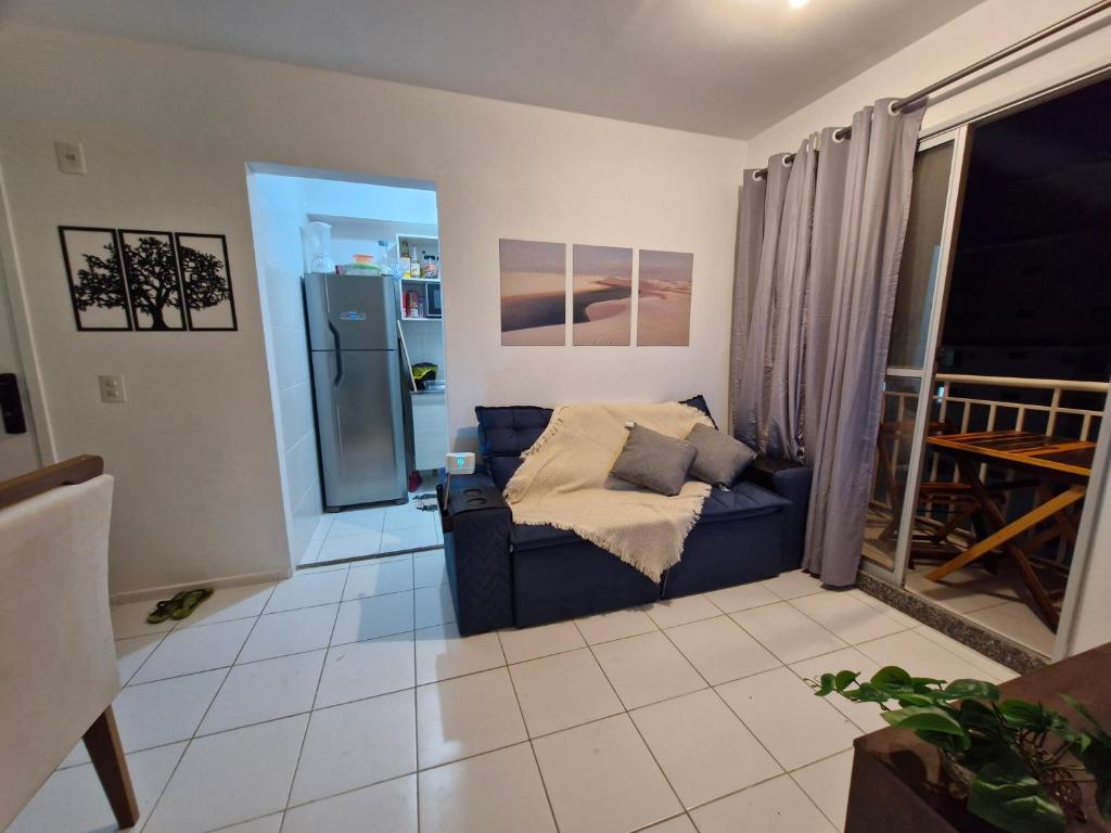 a living room with a couch and a refrigerator at Apto Araçagy Ilha de São Luis in São-José-do-Ribamar