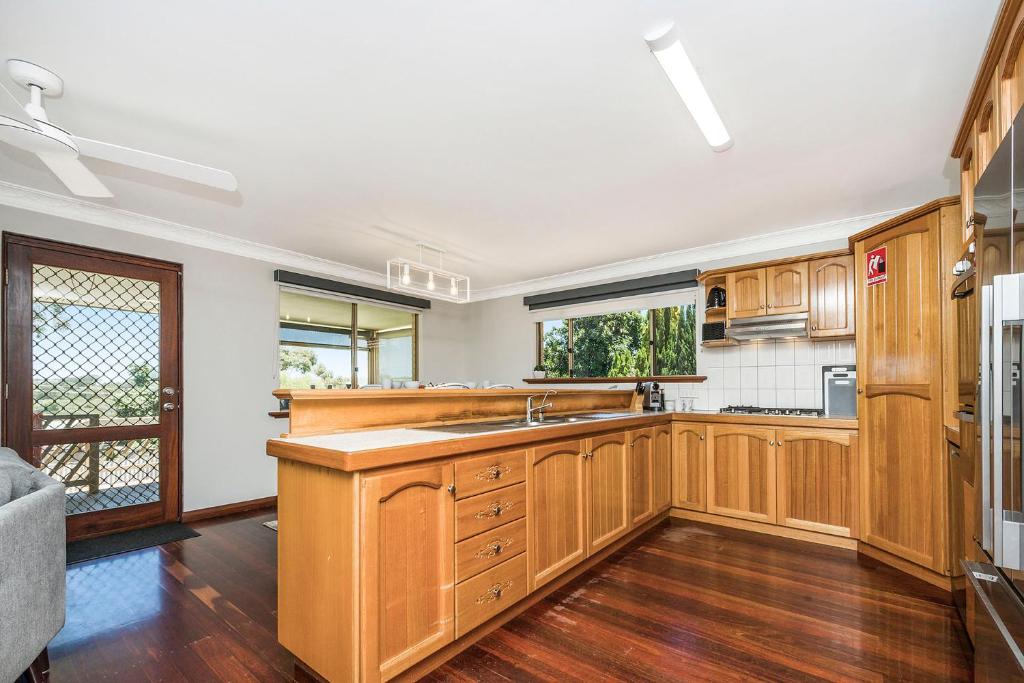a kitchen with wooden cabinets and a sink at Moore than a Shack in Guilderton