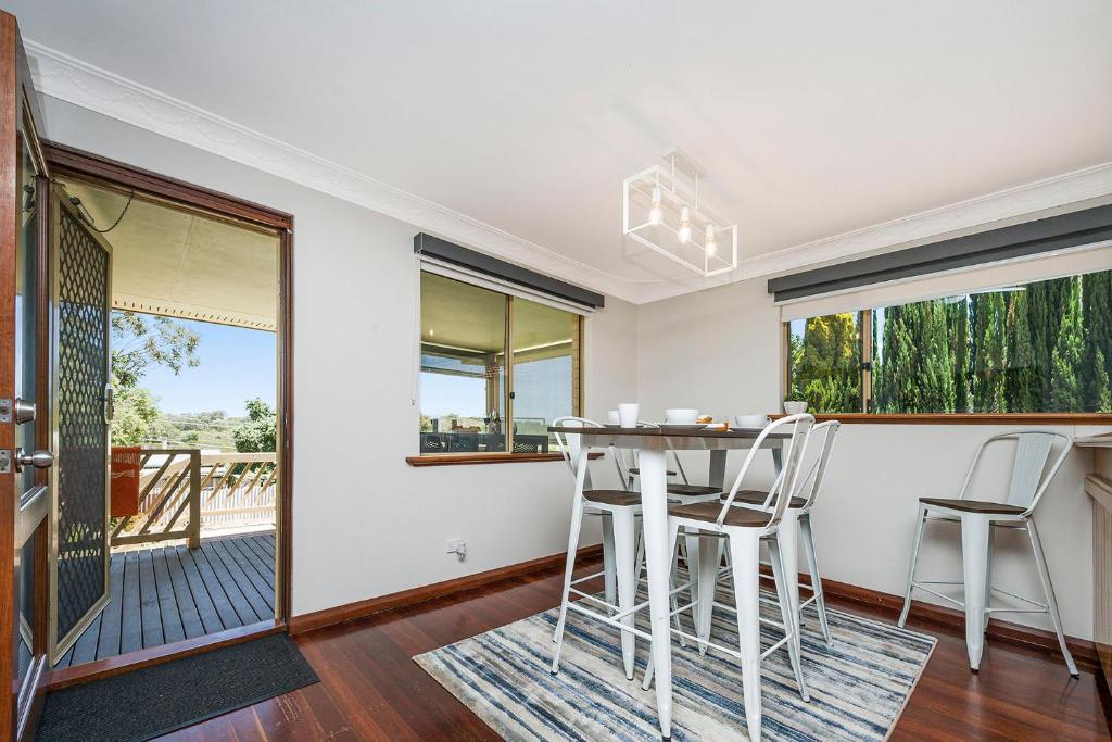 a dining room with a table and two stools at Moore than a Shack in Guilderton