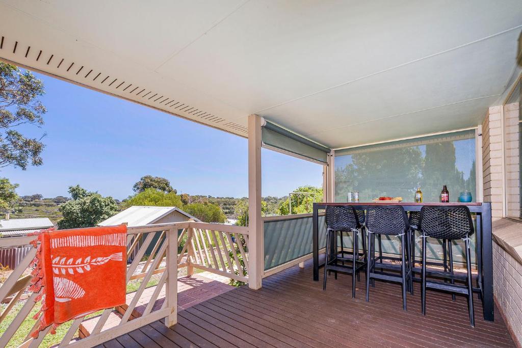 a porch with two chairs and a table on a balcony at Moore than a Shack in Guilderton