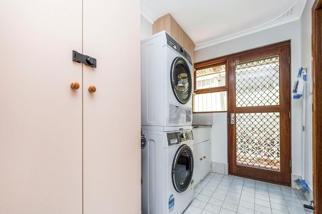 a laundry room with a washer and dryer at Moore than a Shack in Guilderton