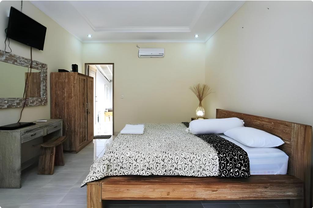 Postel nebo postele na pokoji v ubytování Bale Bali Inn