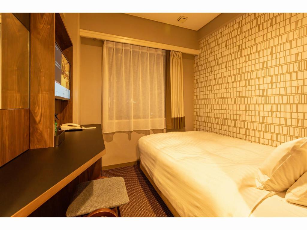 Postel nebo postele na pokoji v ubytování Hotel Odashima