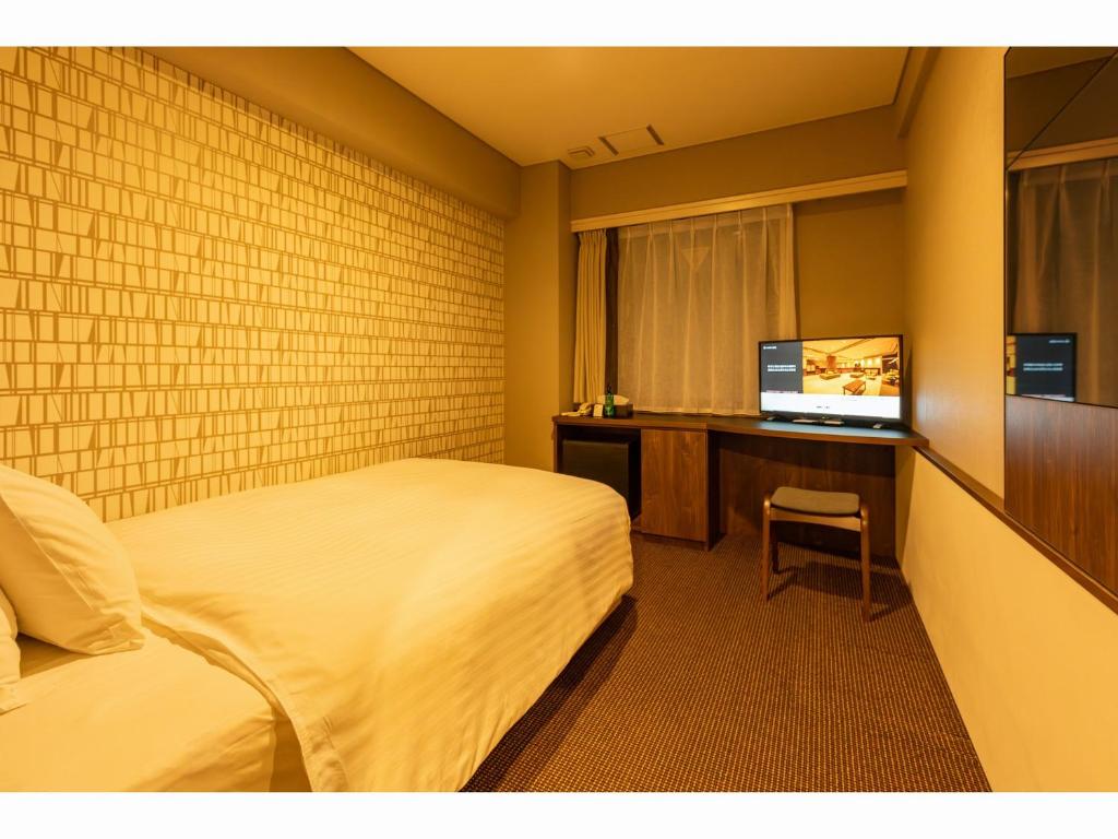 Postel nebo postele na pokoji v ubytování Hotel Odashima