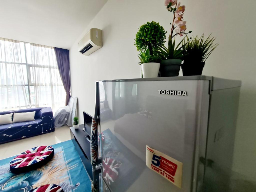 a refrigerator in a room with plants on top of it at First Subang Courtyard SS15 Subang Jaya SJMC Taylors Nu Empire Subang Parade Sunway Pyramid Lagoon Medical Centre LRT KTM in Subang Jaya