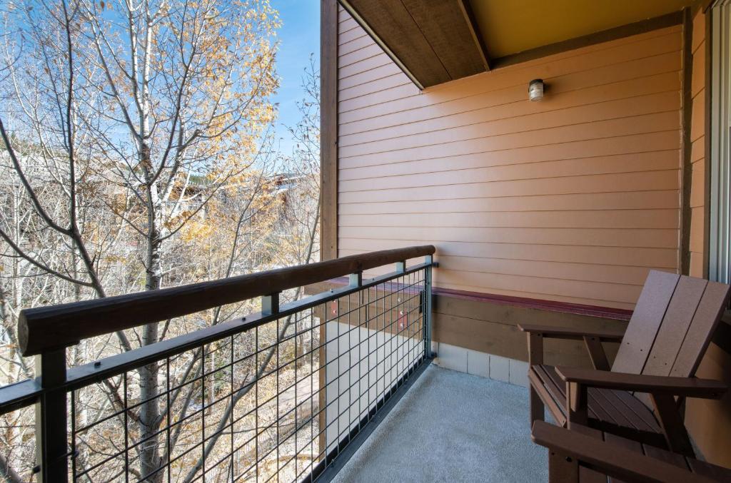a balcony with a bench and a view of a tree at Premium Unit 2308 - 1Br - Zephyr Mountain Lodge condo in Winter Park