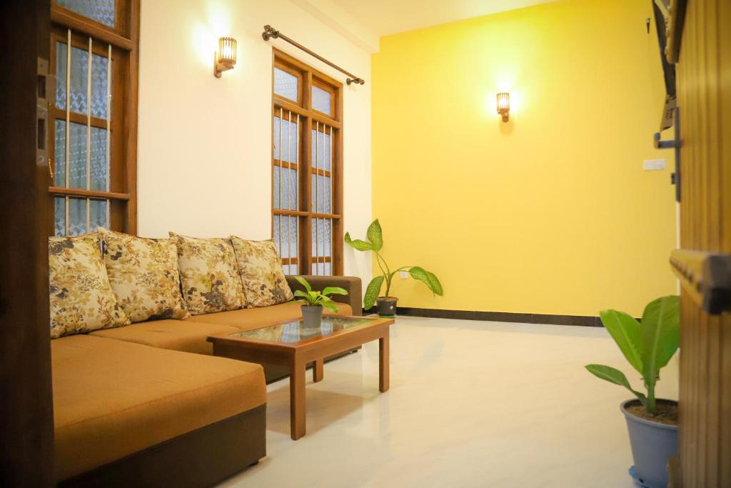 a living room with a couch and a coffee table at Kings Villa Mirissa in Mirissa