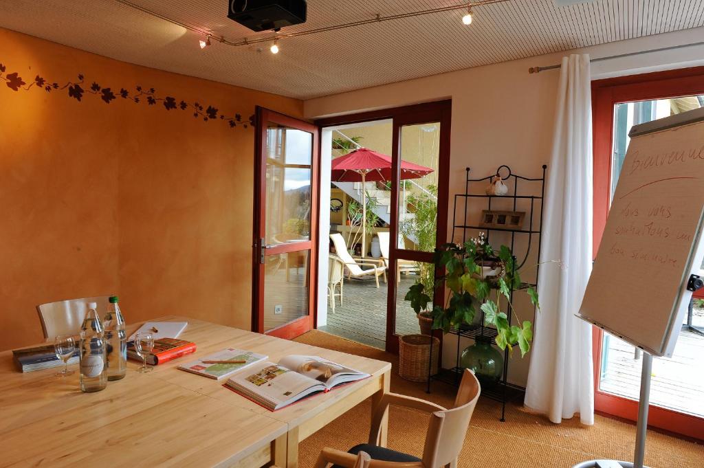 a dining room with a table and a board at EcoHotel L’Aubier in Montézillon