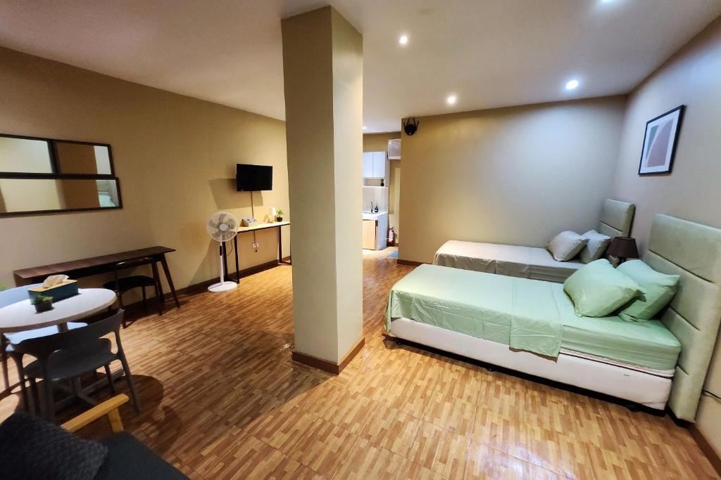 Postel nebo postele na pokoji v ubytování Freddo Studio Apartelle