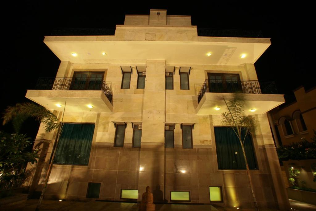 a large building with a tower at night at ​juSTa Gurgaon in Gurgaon