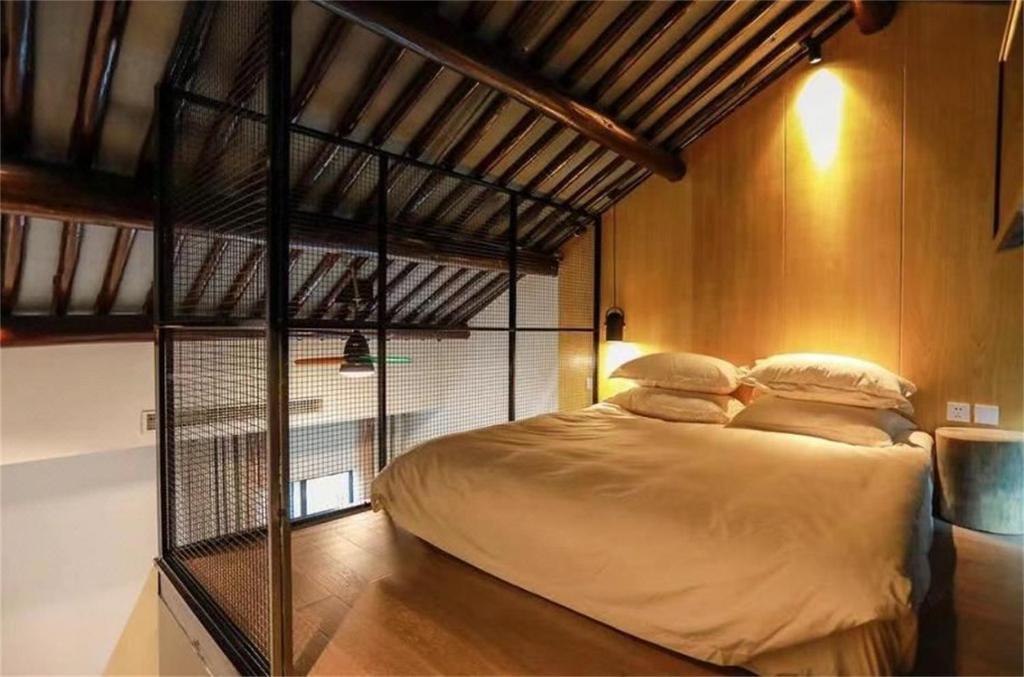 Tempat tidur dalam kamar di Huangliang Yimeng Designer Hotel Wuzhen Xizha Scenic Area Branch