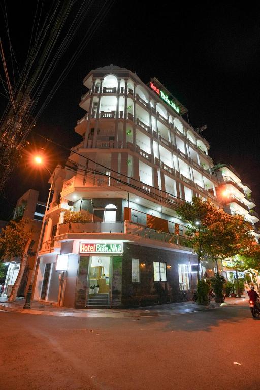 a hotel building with a sign on it at night at Biển Nhớ Hotel & Coffee in Phan Thiet