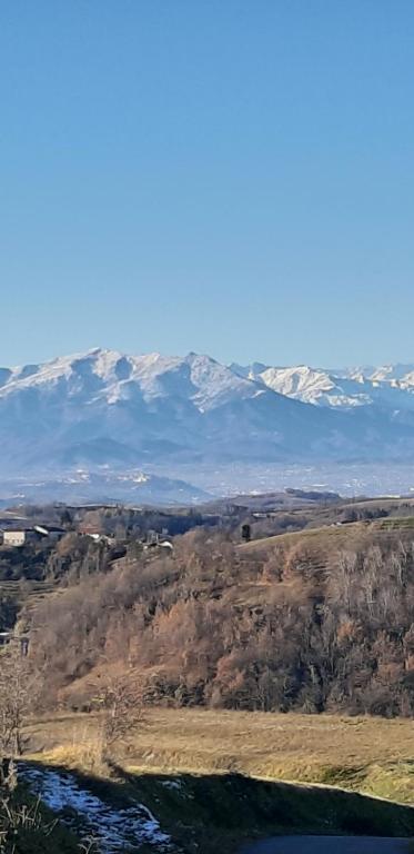 an aerial view of a mountain with snow capped mountains at CASCINA BINELLO appartamenti A & B in Belvedere Langhe