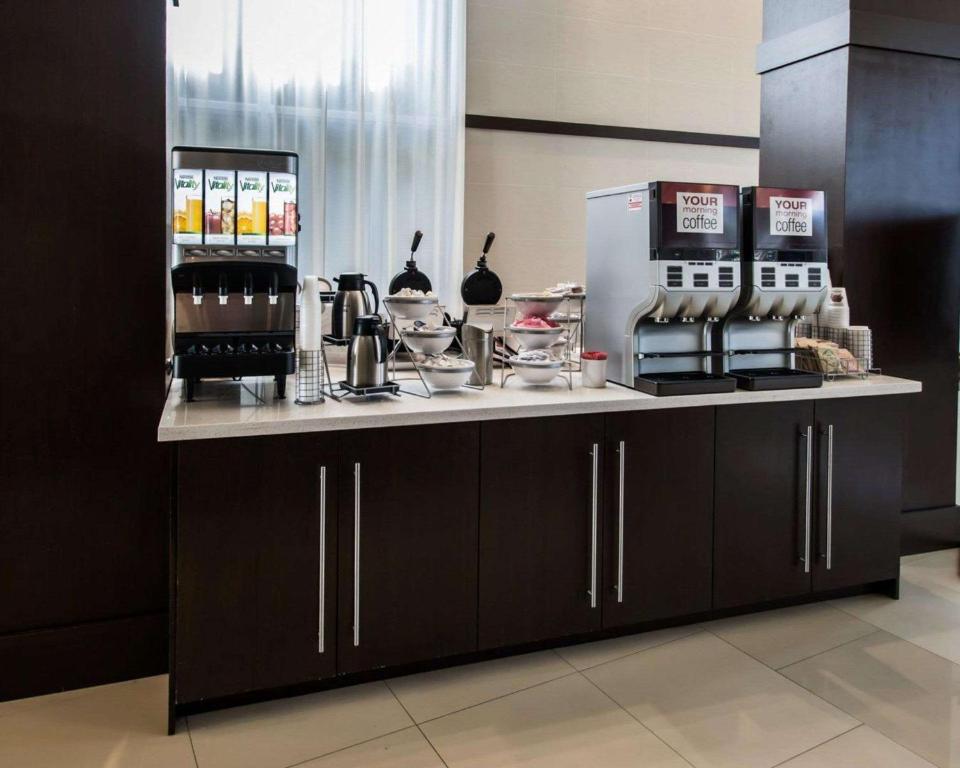 a coffee shop with a counter and a refrigerator at Comfort Suites Miami Airport North in Miami