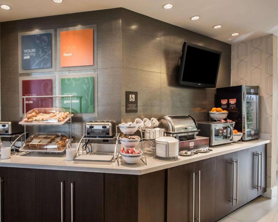 a kitchen with a counter with food on it at Comfort Suites Miami Airport North in Miami