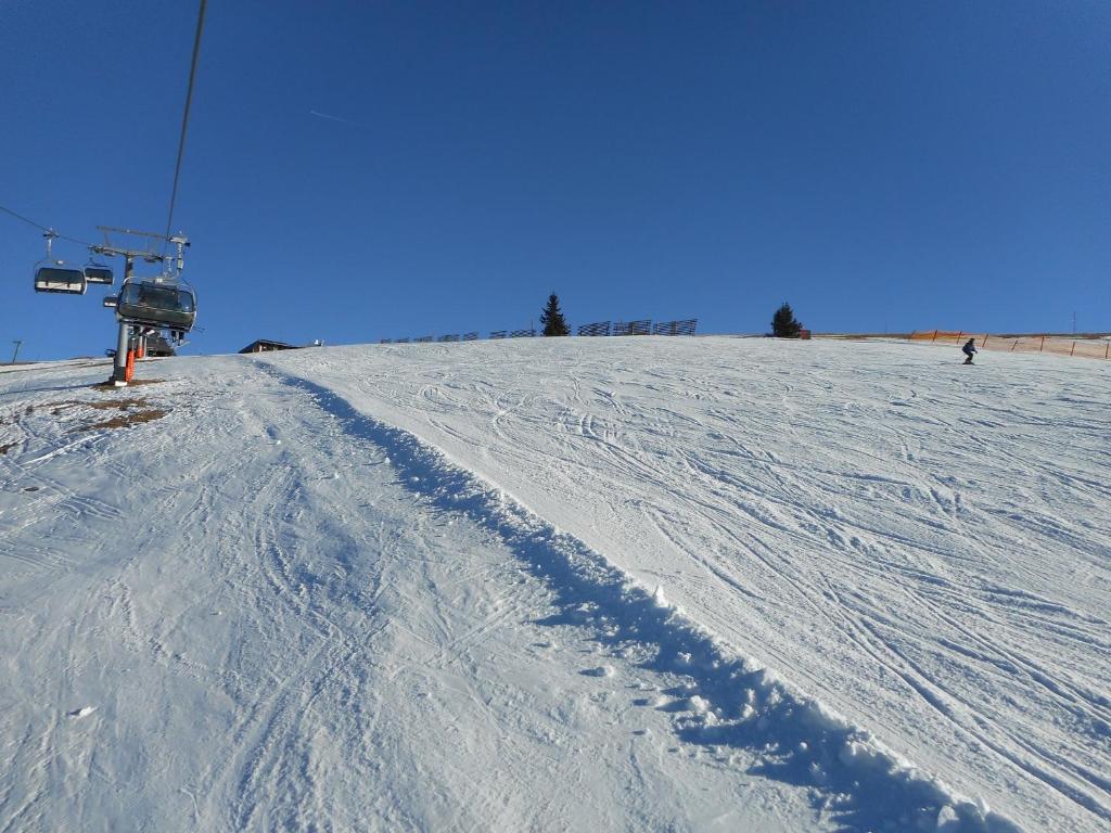 a ski lift on top of a snow covered slope at Villa Relax am See in Bodensdorf