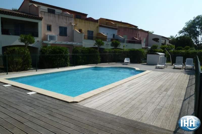 a swimming pool in front of a house at Marinabay 5 in Grimaud