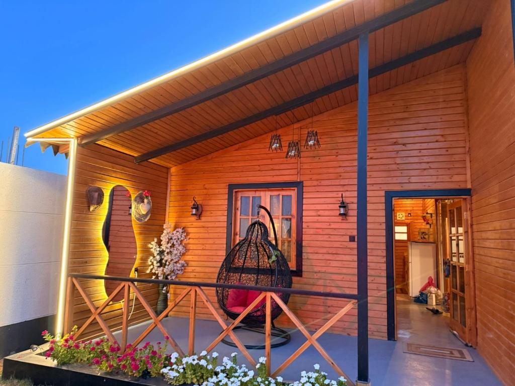 una casa con una gabbia per uccelli sulla facciata di كوخ سترين a Tabuk