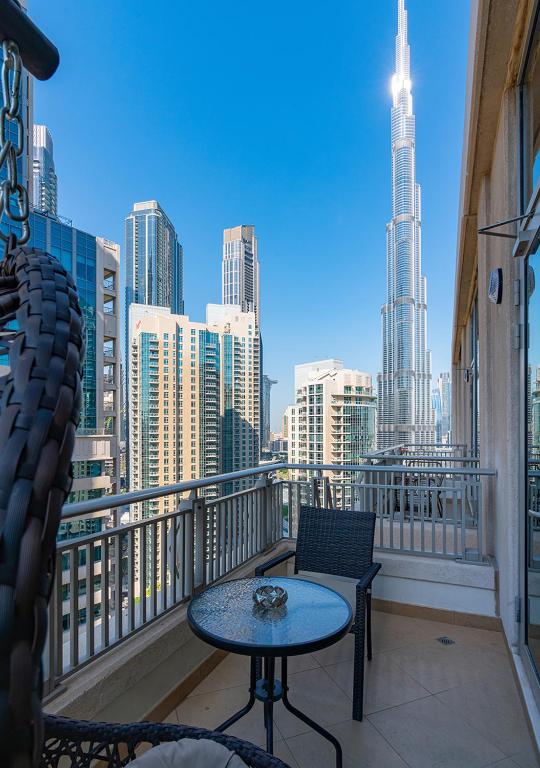 Hotel Luxurious one bedroom Apartment with Burj Khalifa View, a balcony with a table and chairs and a view of a city at Luxurious one bedroom Apartment with Burj Khalifa View in Dubai