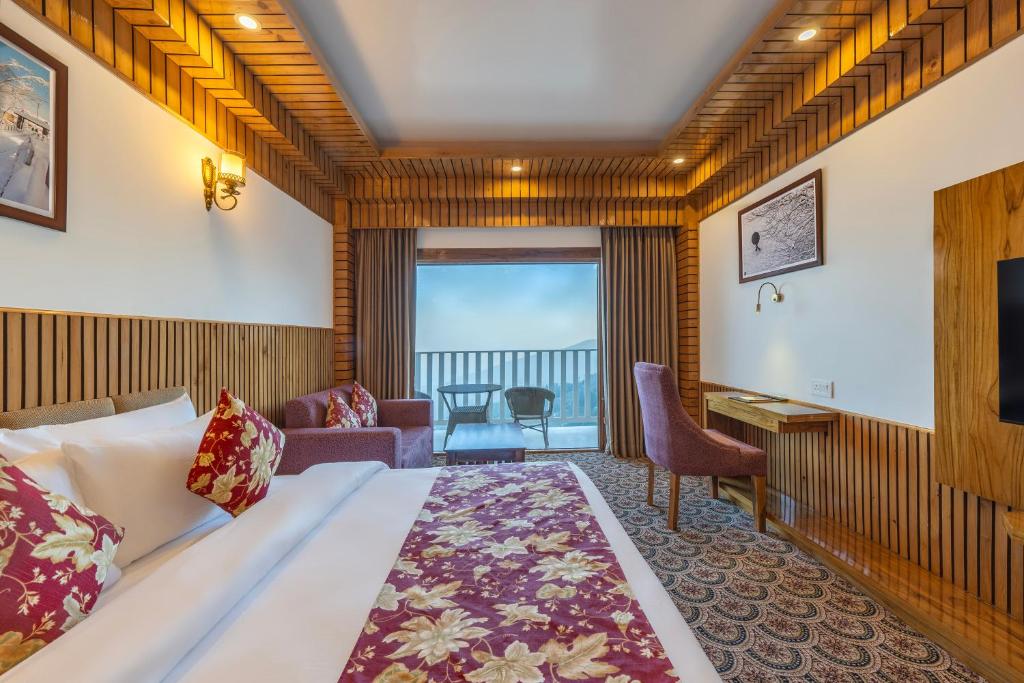 a hotel room with a bed and a view of the ocean at KC Vilaas Kufri in Kūfrī