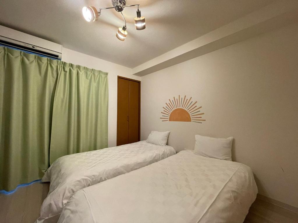 Postel nebo postele na pokoji v ubytování マルチステイ大阪京橋21