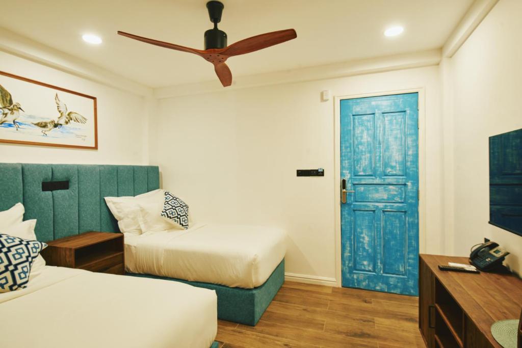 Postel nebo postele na pokoji v ubytování Beach Hotel Dhigurah