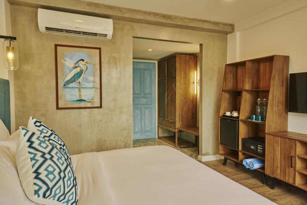 Postel nebo postele na pokoji v ubytování Beach Hotel Dhigurah