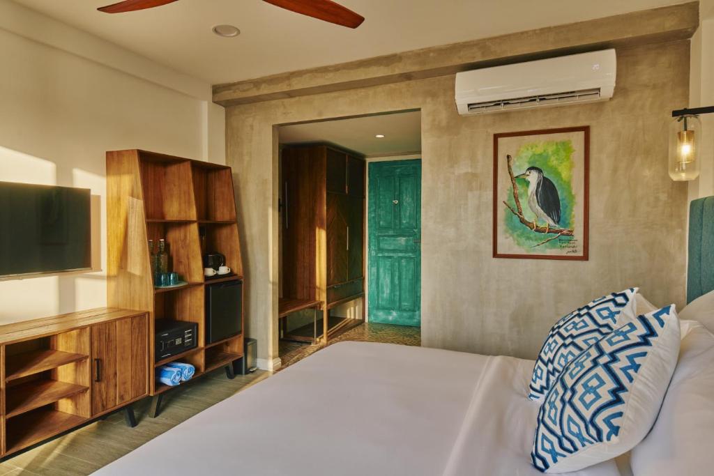 Postel nebo postele na pokoji v ubytování Beach Hotel Dhigurah
